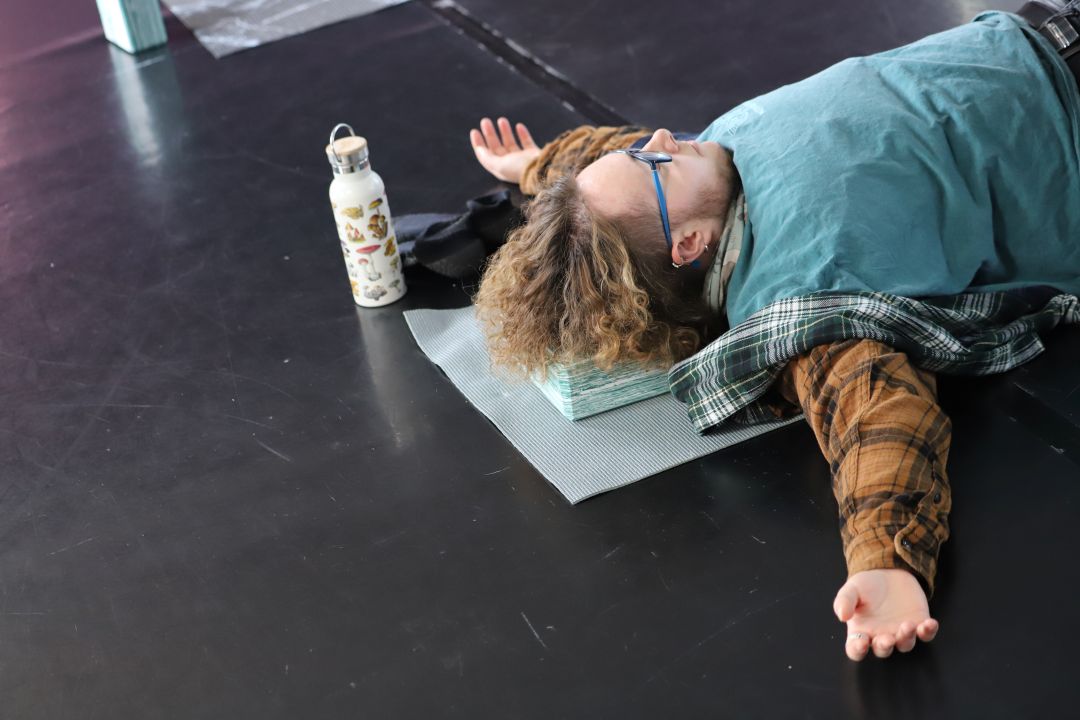 Man relaxing on the floor, arms out