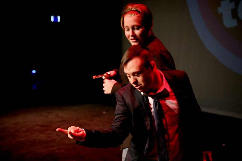 Two young male dancers pointing forwards